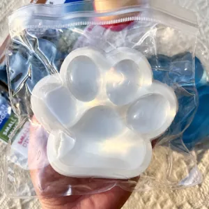 Close-up of jumbo cat paw squishy toy made of soft TPR material in a clear bag