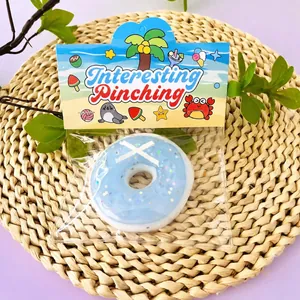Detail view of the blue donut-shaped TPR squishy toy in colorful beach packaging