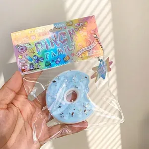 Blue donut squishy toy from the sea salt series with glitter stars in its package.