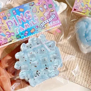 Close-up of a blue sea salt waffle squishy toy with glitter details in its packaging
