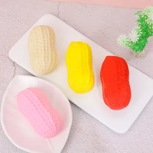 Close-up of colorful peanut-shaped squishy toys for stress relief on white plates.
