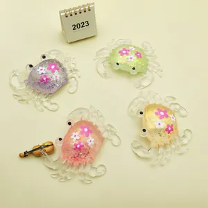 Detailed view of four colorful glitter-filled crab squeeze toys on a yellow background