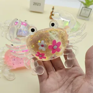 Detailed view of a glittery crab-shaped squishy toy held in hand for sensory play