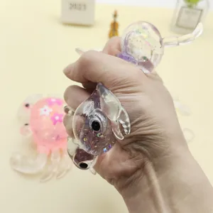 Detail shot of a hand squeezing a purple glittery crab maltose toy for stress relief