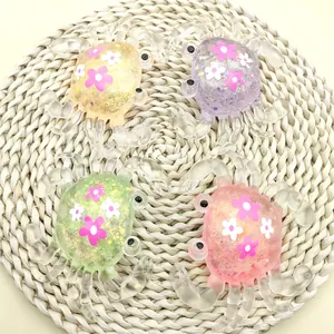 Macro view of colorful glitter maltose crab squishy stress relief toys on a woven mat