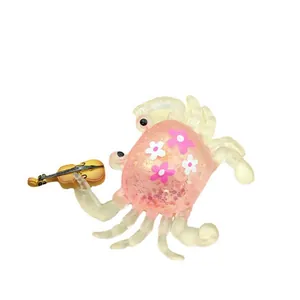 Cute maltose crab squishy toy featuring pink glitter and a mini violin accessory