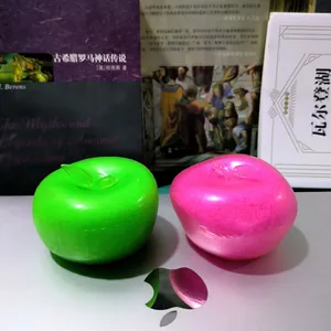 Close-up of pink and green apple squishy toys with slushy texture