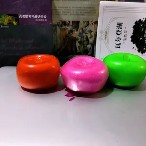 Nahaufnahme von drei bunten Slushy-Apfel-Squishies in Rot, Rosa und Grün.