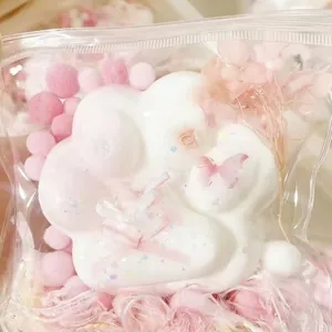 Close-up of a cute white silicone cat paw squishy toy featuring a pink butterfly.