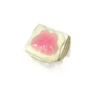 Detailed view of cat paw themed squishy bread toy in clear plastic packaging for stress relief