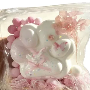 Large white silicone cat paw squishy toy with pink butterfly and glitter in gift bag