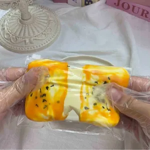 Handmade silicone squeeze toy shaped like stretching seaweed cheese rice cake for stress relief.