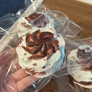 Close-up of a swirl cream-shaped squishy toy in chocolate and milk white colors