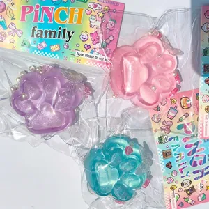 Detail view of colorful glittery cat paw silicone squishies in packaging