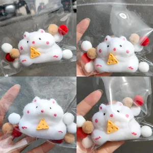 Detailed macro view showing a cute white hamster squishy toy with a cheese prop