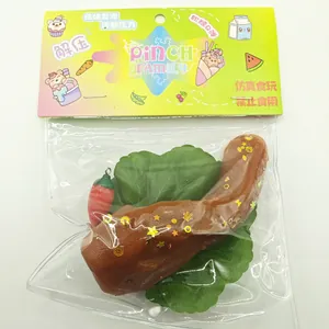Close-up of brown duck head squishy toy with gold glitter stars in transparent packaging bag