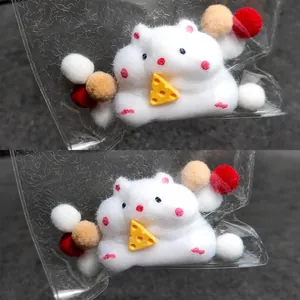 Close-up of a cute white hamster squeeze toy holding cheese in crispy packaging