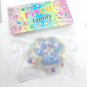 Macro view of purple cat paw squishy toy with glitter in colorful retail packaging