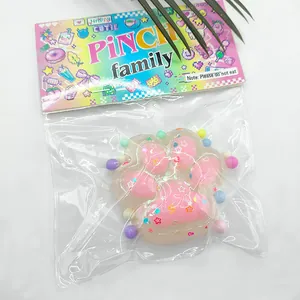 Close-up of a pink cat paw squishy toy inside a colorful PINCH family package