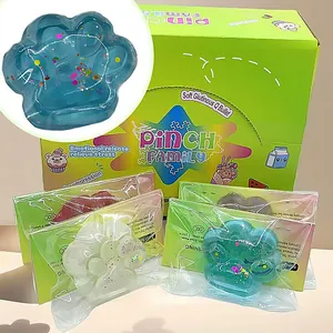 Detailopname van een kleurrijk glitter kattenpootje knijpspeeltje in een groene doos