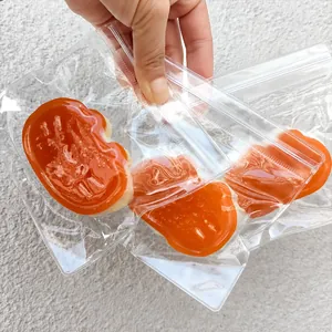 Close-up of cute orange cheese cat squishy stress relief toys in transparent bags.