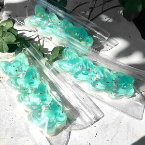 Close-up of butterfly-shaped squishy toys in transparent packaging under bright sunlight