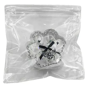 Detail of transparent cat paw squishy with butterfly and glitter inside packaging