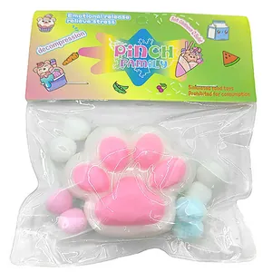 Detail view of a pink cat paw shaped squishy stress relief toy in colorful package