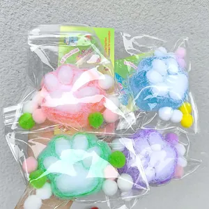 Set of four colorful flocked cat paw squishy toys in pink, blue, green, and purple