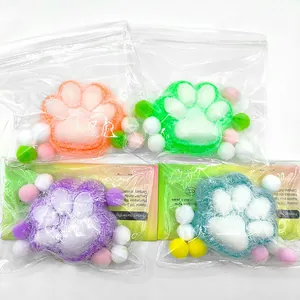 Close-up macro view of plush flocked cat paw squeeze toys in colorful individual packaging