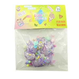 Purple cat paw squishy toy with glitter decorations in Pinch Family packaging for stress relief