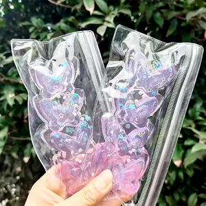 Detailed view of four-connected purple butterfly squishy toy with glitter in a clear bag