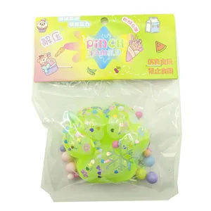Detailed view of a green cat paw squishy toy inside its colorful retail packaging.