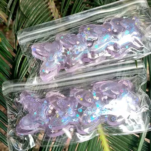 Macro view of purple glitter butterfly squishy stress relief toys in clear plastic bags