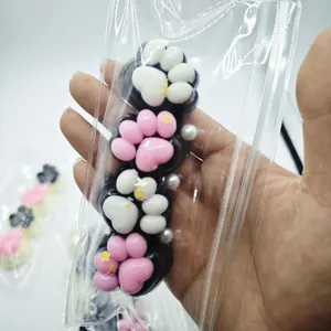 Detail view showing a soft 4-link cat paw squishy squeeze toy in pink and white