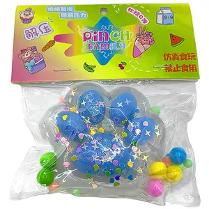 Detail of sun-sensitive color-changing cat paw squishy toy with glitter in clear packaging