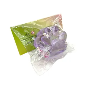 Purple cat paw squishy toy with butterfly and pearl decorations for stress relief relief
