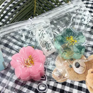 Close-up of traditional Chinese osmanthus cake squeeze toys in pink and green packaging.
