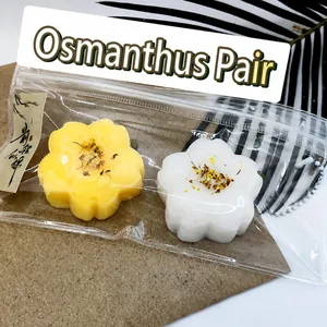 Detailed macro view of yellow and white osmanthus cake squeeze toys in transparent packaging