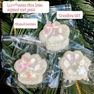 Detailed macro view of a pearlescent cat paw squishy toy in transparent packaging.