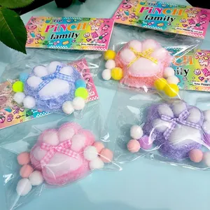 Detail shot of colorful cat paw shaped squishy toys with plaid bows in packaging