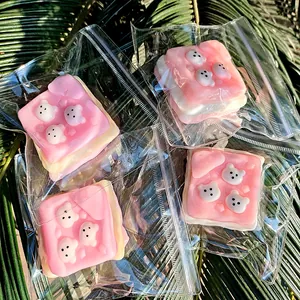 Detail view of cute pink Westie puppy toast squeeze toys individually wrapped for stress relief