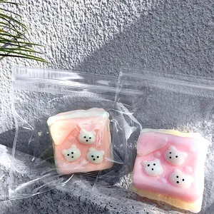 Close-up of cute pink puppy toast squishy decompression toys in clear plastic zip bags
