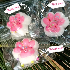 Cute pink and white cat paw squishy stress relief toy with decorative sequins and pearls.