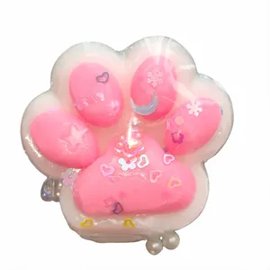 Cute pink and white cat paw shaped squishy toy for stress relief with colorful glitters