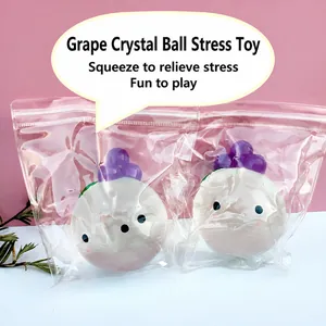 Detailed view of DIY crystal grape squeeze toy in transparent plastic packaging.