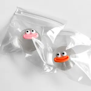Detailed macro shot of a transparent crystal ball squeeze toy with a cute cartoon face