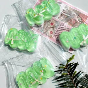 Detailed macro of mint green cream bar squishies with stars and ribbons decoration