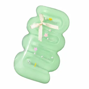 Detailed macro view of mint green wavy cream bar squishy toy with white ribbon bow