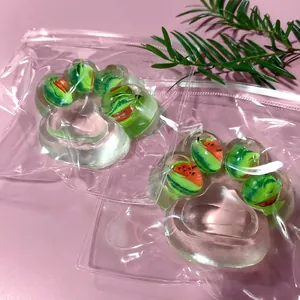Close-up of transparent watermelon-patterned cat paw squishy toys in bags.